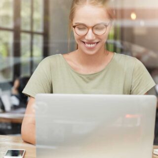 Happy woman with glasses cafe