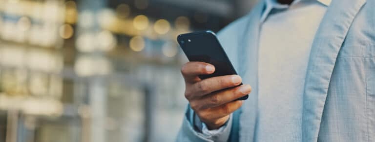 Travel business man hand with phone in city typing and walking, networking or on 5g mobile app in New York